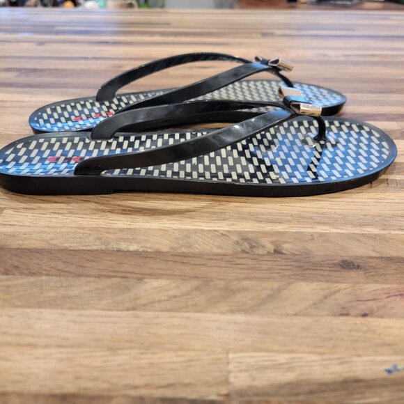 Coach Landon jelly flip flops in black with a gold bow and white pattern. - Picture 8 of 12